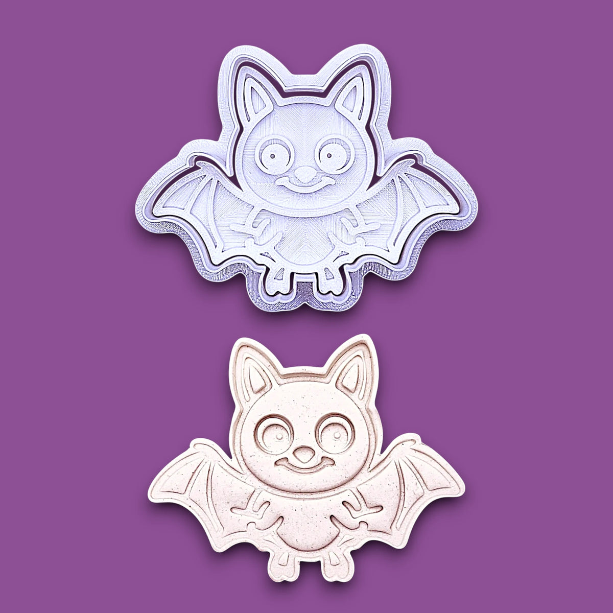 Bat cookie cutter with matching stamp alongside a dough cutout and imprint, perfect for spooky Halloween cookies, fondant crafts, and gothic-themed baking projects.