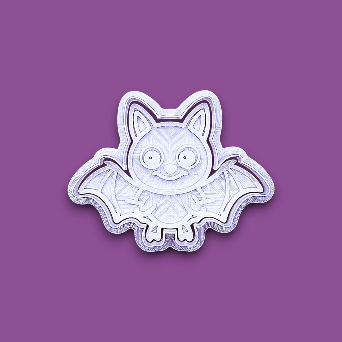 Bat cookie cutter with matching stamp, perfect for spooky Halloween cookies, fondant crafts, and gothic-themed baking projects.