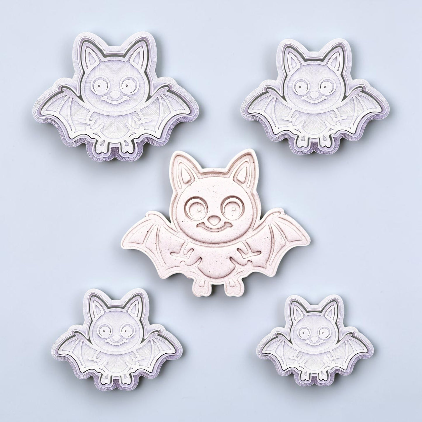 Close-up of bat cookie cutters with matching stamps, perfect for spooky Halloween cookies, fondant crafts, and gothic-themed baking projects.