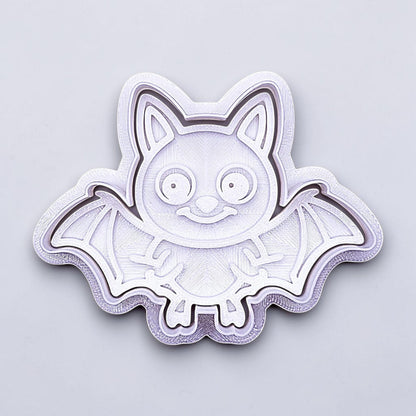 Close-up of bat cookie cutter with matching stamp, perfect for spooky Halloween cookies, fondant crafts, and gothic-themed baking projects.