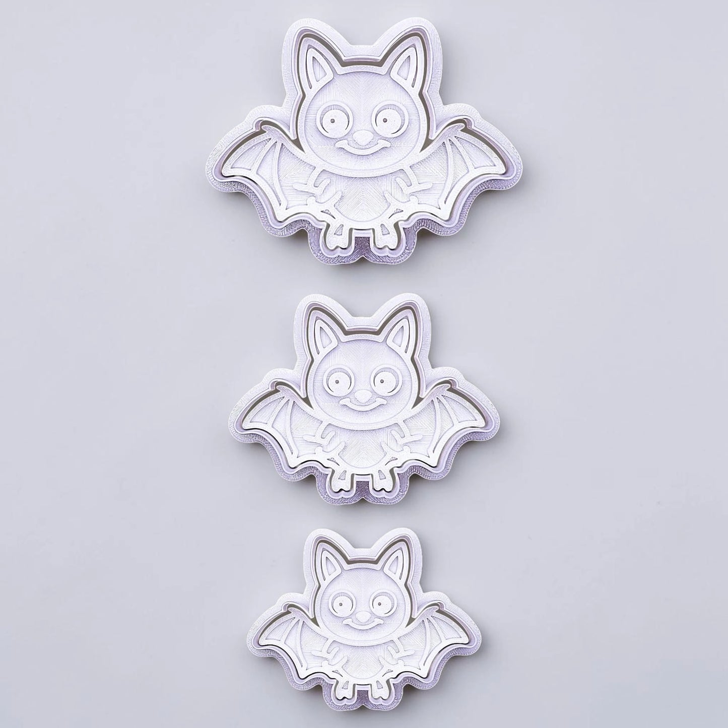 Bat cookie cutters with matching stamps, perfect for spooky Halloween cookies, fondant crafts, and gothic-themed baking projects.