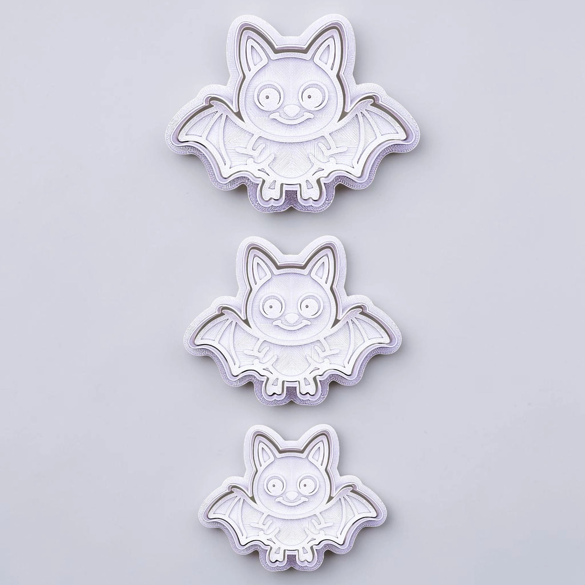Bat cookie cutters with matching stamps, perfect for spooky Halloween cookies, fondant crafts, and gothic-themed baking projects.