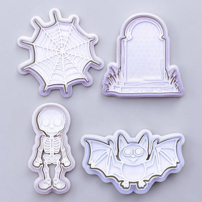Set of Halloween-themed cookie cutters including a spider web, tombstone, skeleton, and bat on a light gray background.