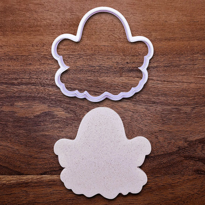 Handmade and customizable ghost cookie cutter alongside a dough cutout and imprint, great for baking Halloween trick or treats or kid-friendly spooky snacks.