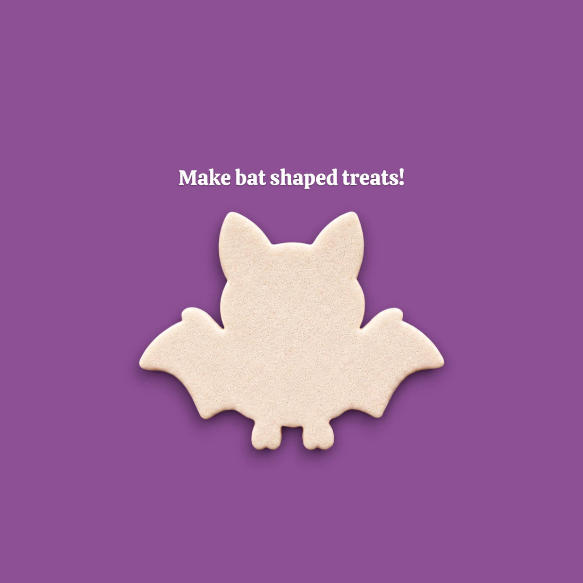 Cookie dough cutouts made with bat cookie cutter. Shows bat and wing shape, ideal for cute Halloween treats.