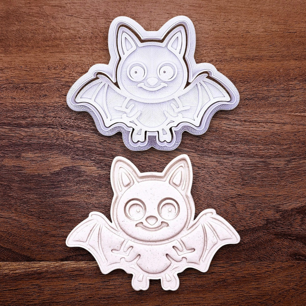 Bat cookie cutter with matching stamp and cutout, perfect for spooky Halloween cookies, fondant crafts, and gothic-themed baking projects.