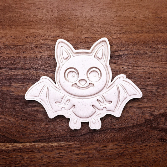 Close-up of bat cookie cutter dough imprint, perfect for spooky Halloween cookies, fondant crafts, and gothic-themed baking projects.