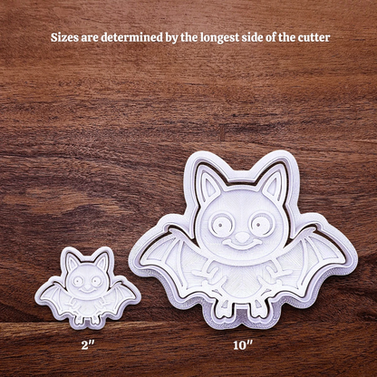 Two bat-shaped cookie cutters with sizes indicated on a light gray background, showing how size increases work.