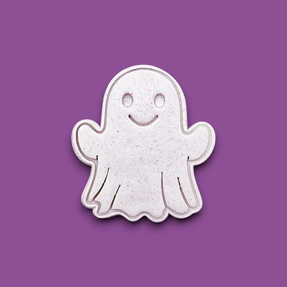 Ghost cookie cutter stamping spooky face into dough – great for Halloween cookies, fondant, or crafts with clean, detailed imprints.