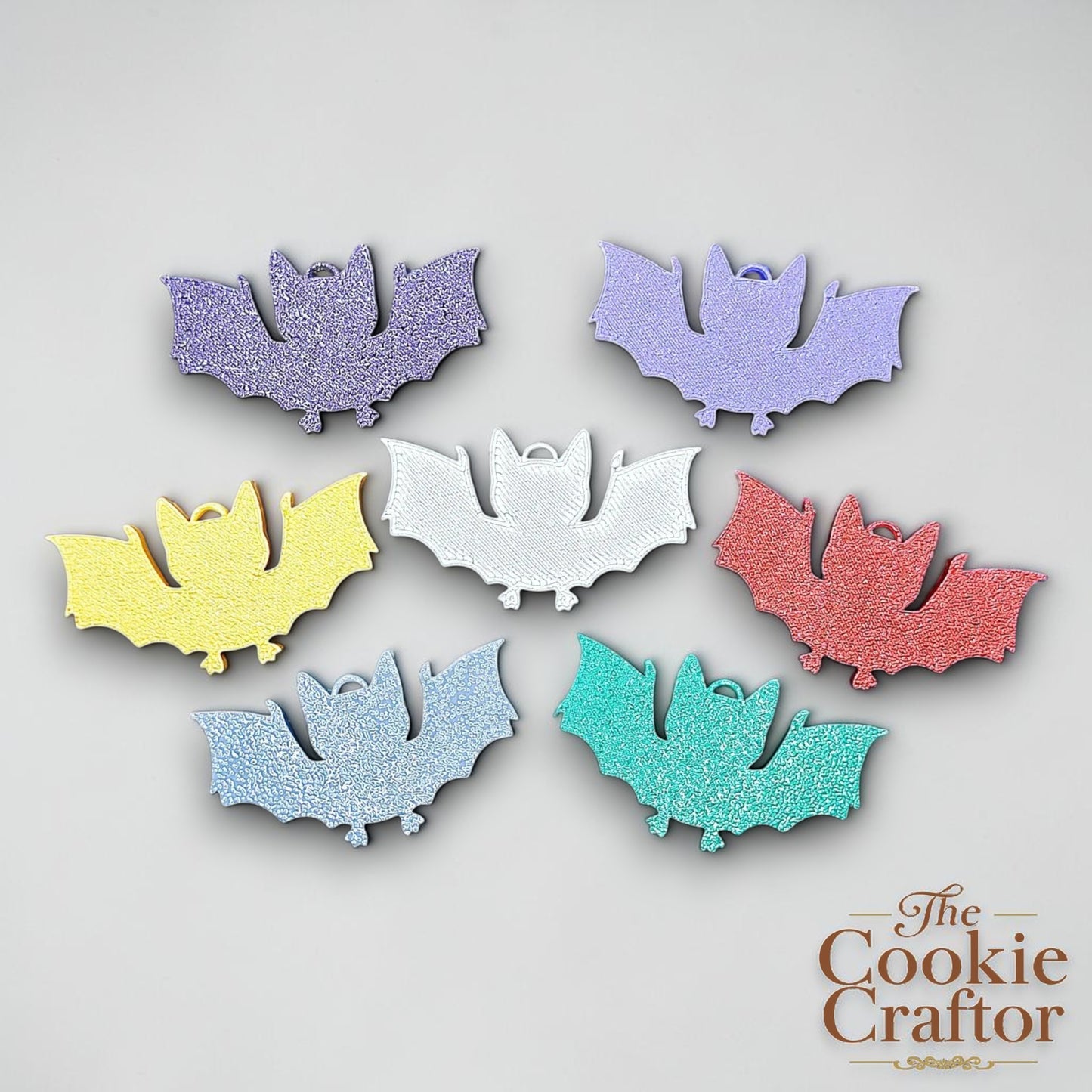 Handmade and customizable bat keychains in assorted colors, perfect for Halloween trick or treats, gothic party favors, and bat-themed accessories.