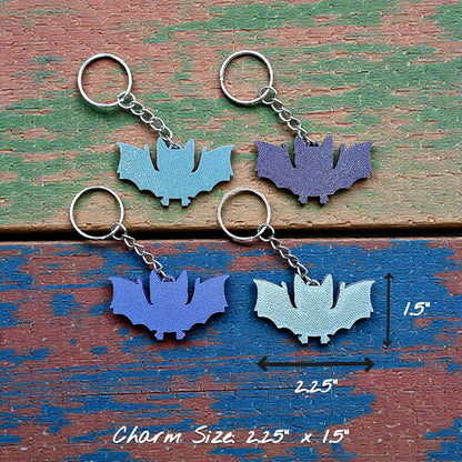 Handmade and customizable bat keychains in four colors, perfect for Halloween trick or treats, gothic party favors, and bat-themed accessories.