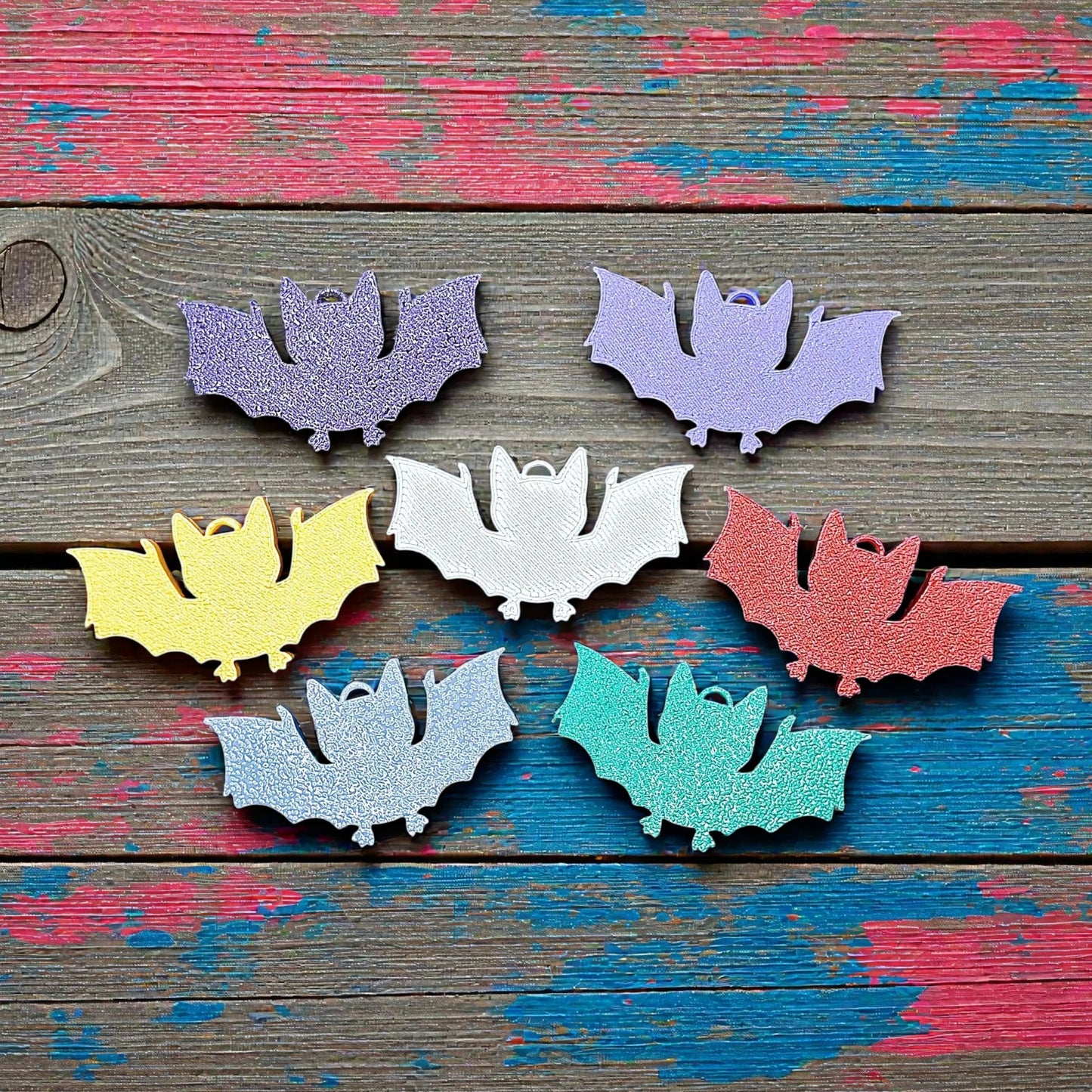 Handmade and customizable bat keychains in assorted colors, perfect for Halloween trick or treats, gothic party favors, and bat-themed accessories.