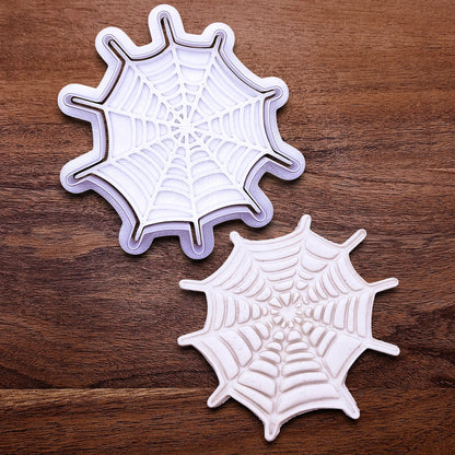 Handmade and customizable Halloween spiderweb cookie cutter and stamp alongside a spiderweb dough cutout and imprint, perfect for fall parties, events, trick or treats, and gifting.