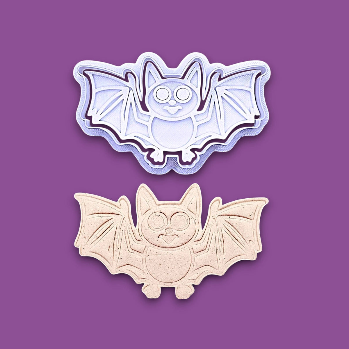 Bat cookie cutter with matching stamps and dough cutout with bat design pressed by cutter and stamp set, showing detailed lines - great for easy Halloween cookie decorating without icing.