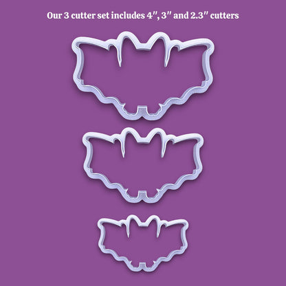Three bat-shaped cookie cutters in sizes 4 inches, 3 inches, and 2.3 inches, shown as white plastic outlines on a solid purple background with white text at the top stating 'Our 3 cutter set includes 4", 3" and 2.3" cutters'