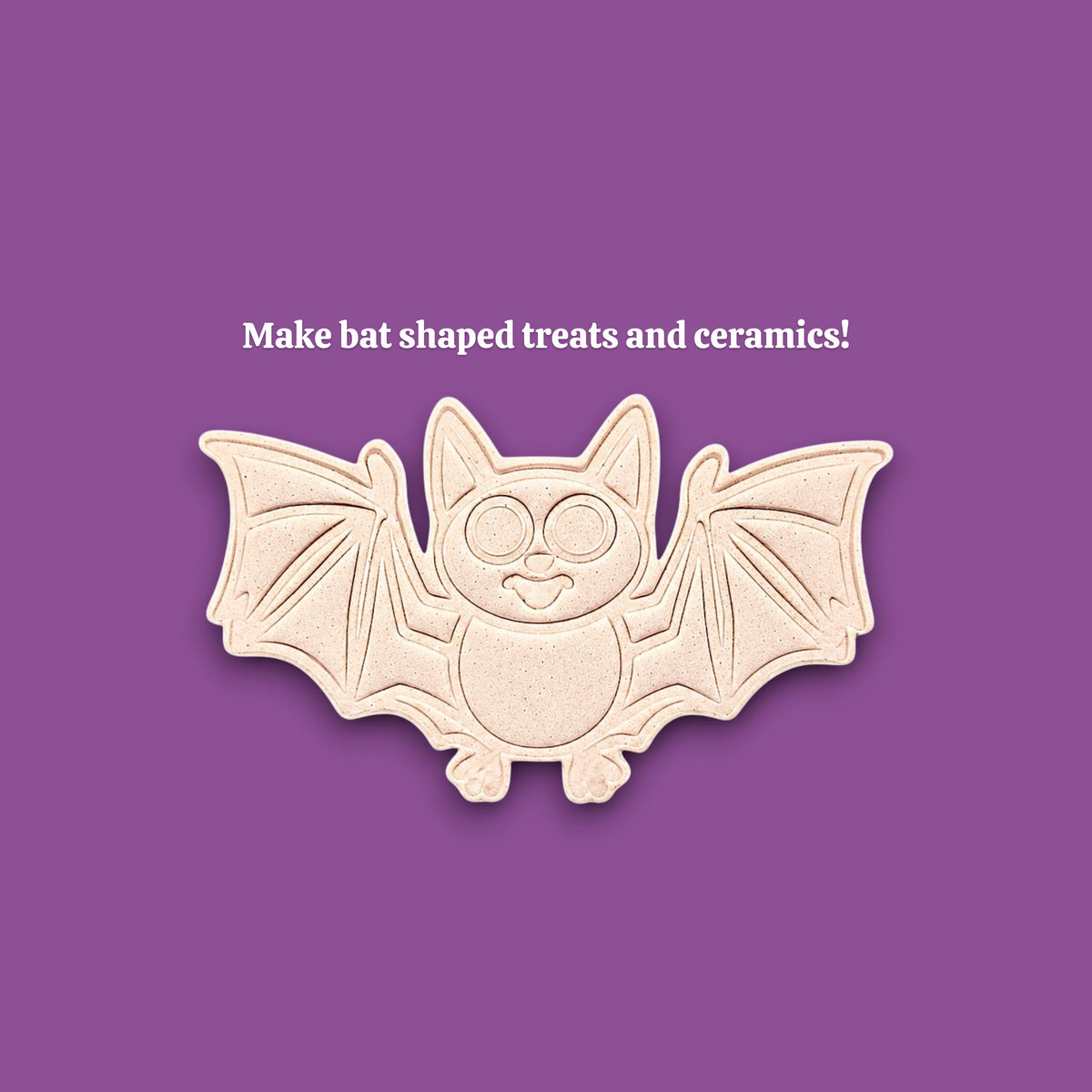 A bat-shaped cookie cutter ceramic mold centered on a solid purple background, with the text 'Make bat shaped treats and ceramics!' above it.
