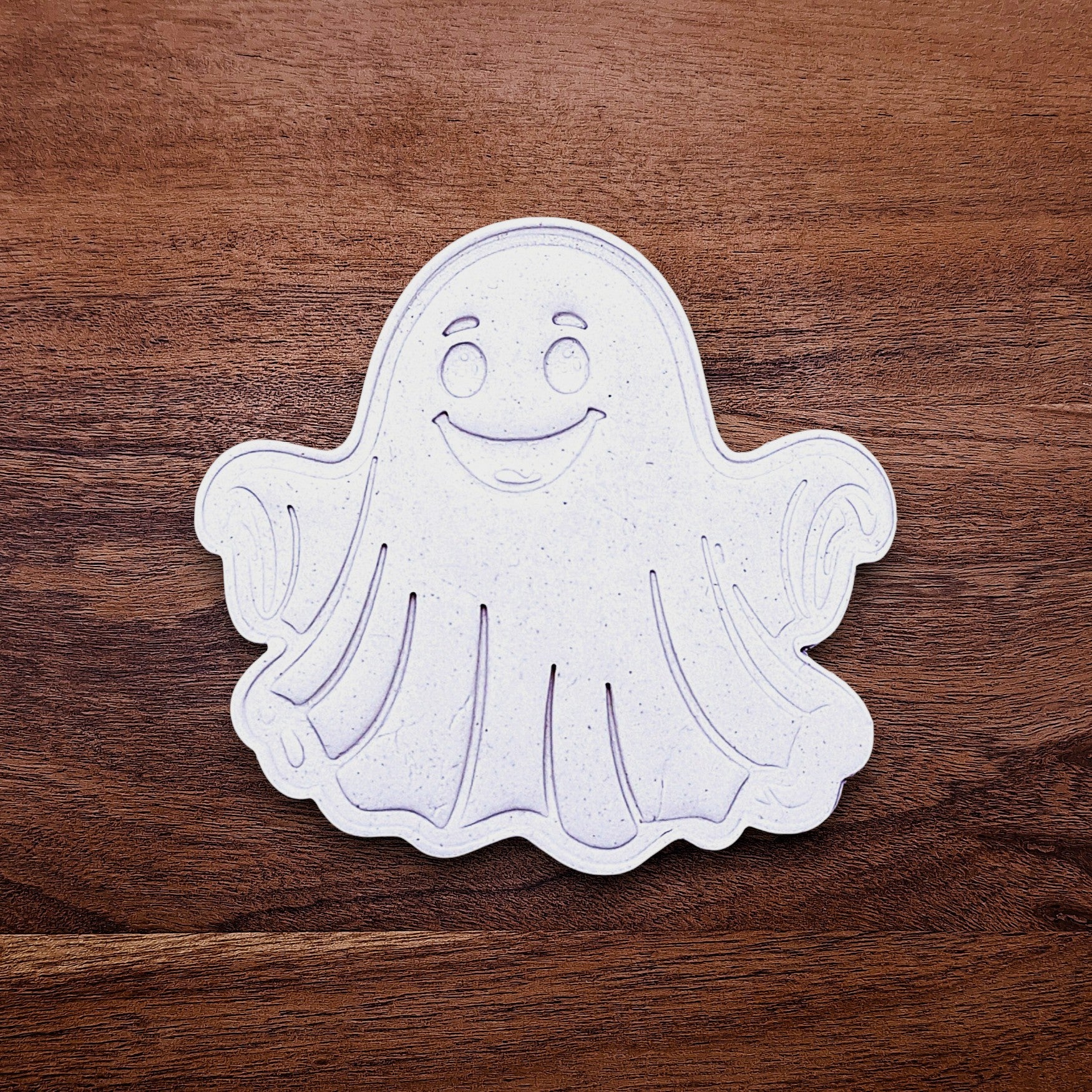 Ghost cookie dough cutouts with smiling face and floating arms. Perfect for cute Halloween treats, fall parties, or baking with kids.