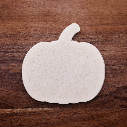 Freshly cut pumpkin-shaped cookie dough using the cutter; shows clean edges and festive form, perfect for seasonal baking projects.