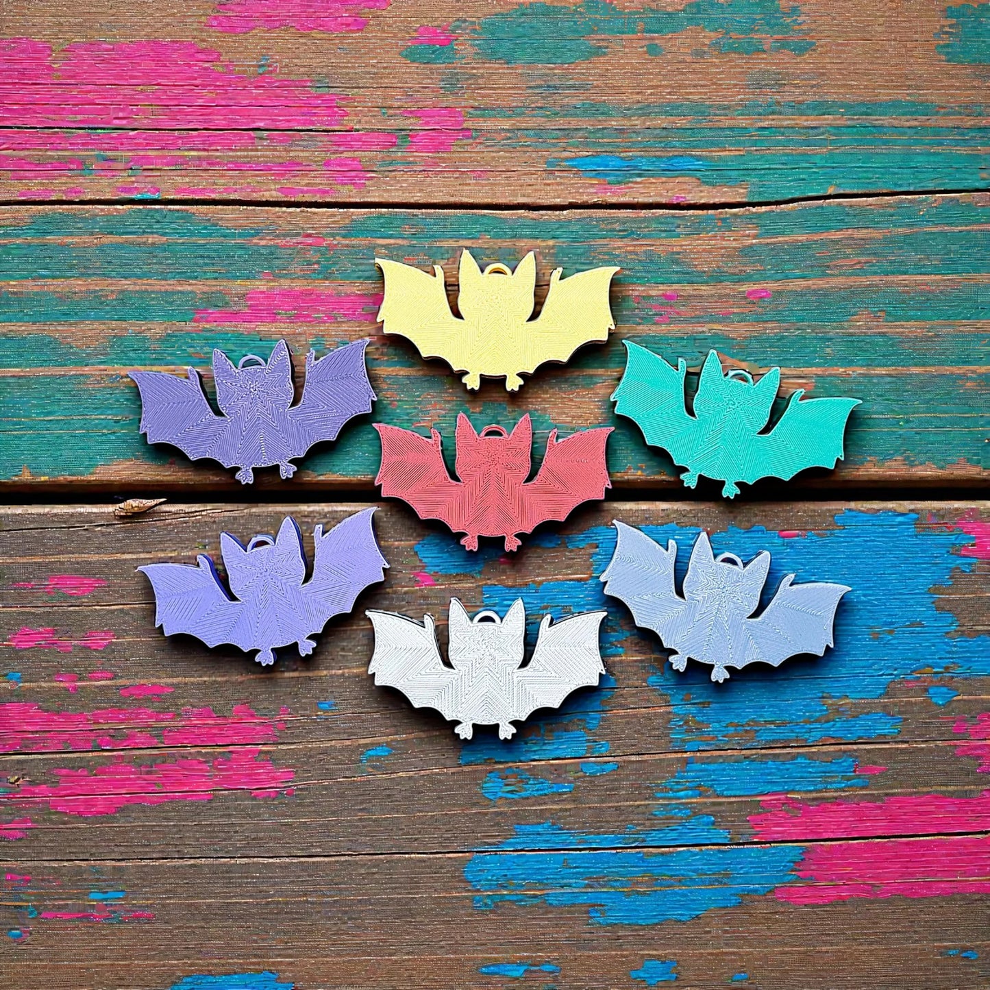 Reverse of handmade and customizable bat keychains, perfect for Halloween trick or treats, gothic party favors, and bat-themed accessories.