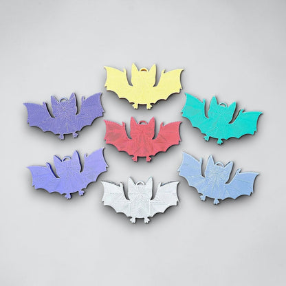 Reverse of handmade and customizable bat keychains, perfect for Halloween trick or treats, gothic party favors, and bat-themed accessories.