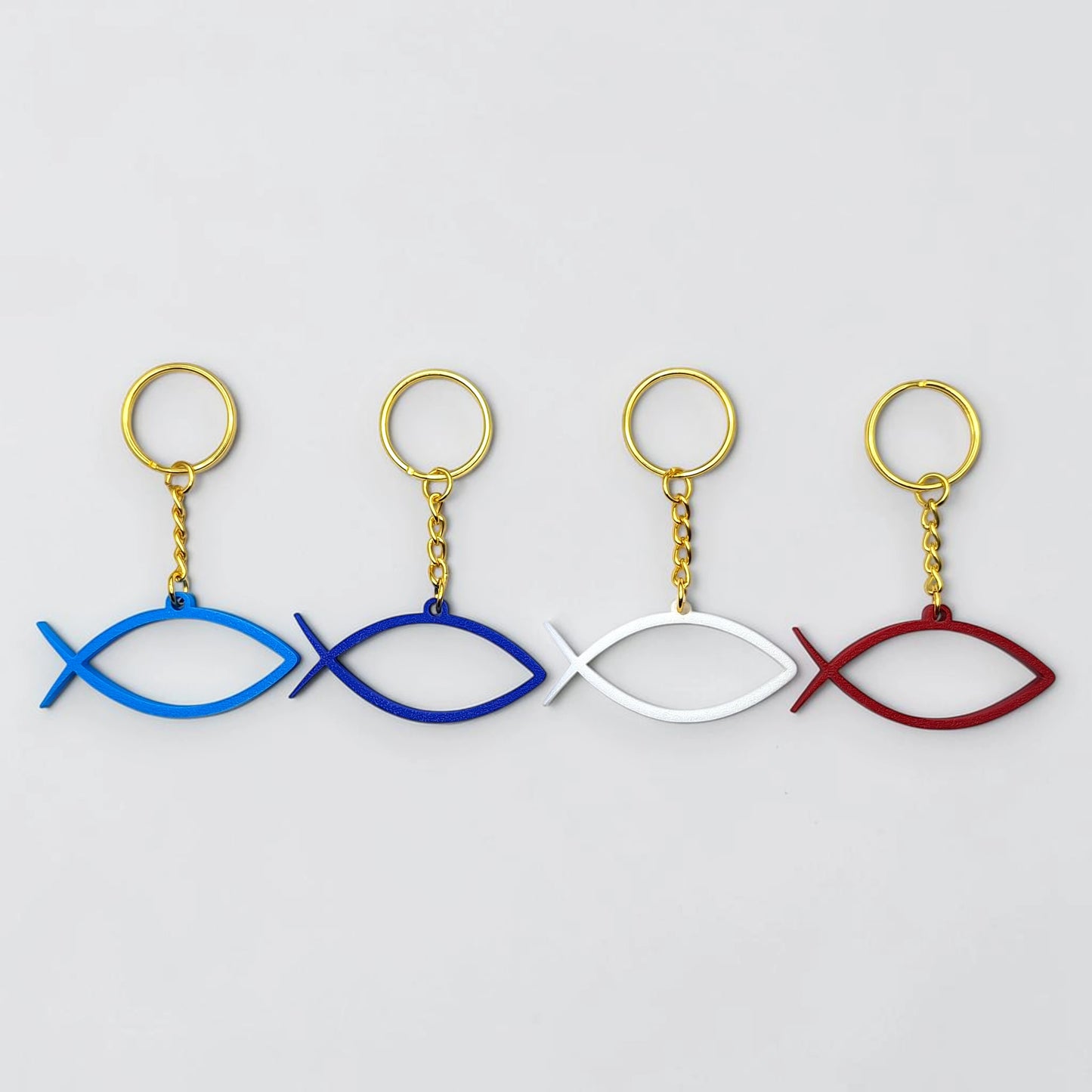 Handmade and customizable Ichthys Fish Keychains in various colors with gold keyrings, inspirational religious charms for Easter gifts, VBS giveaways, and church favors.