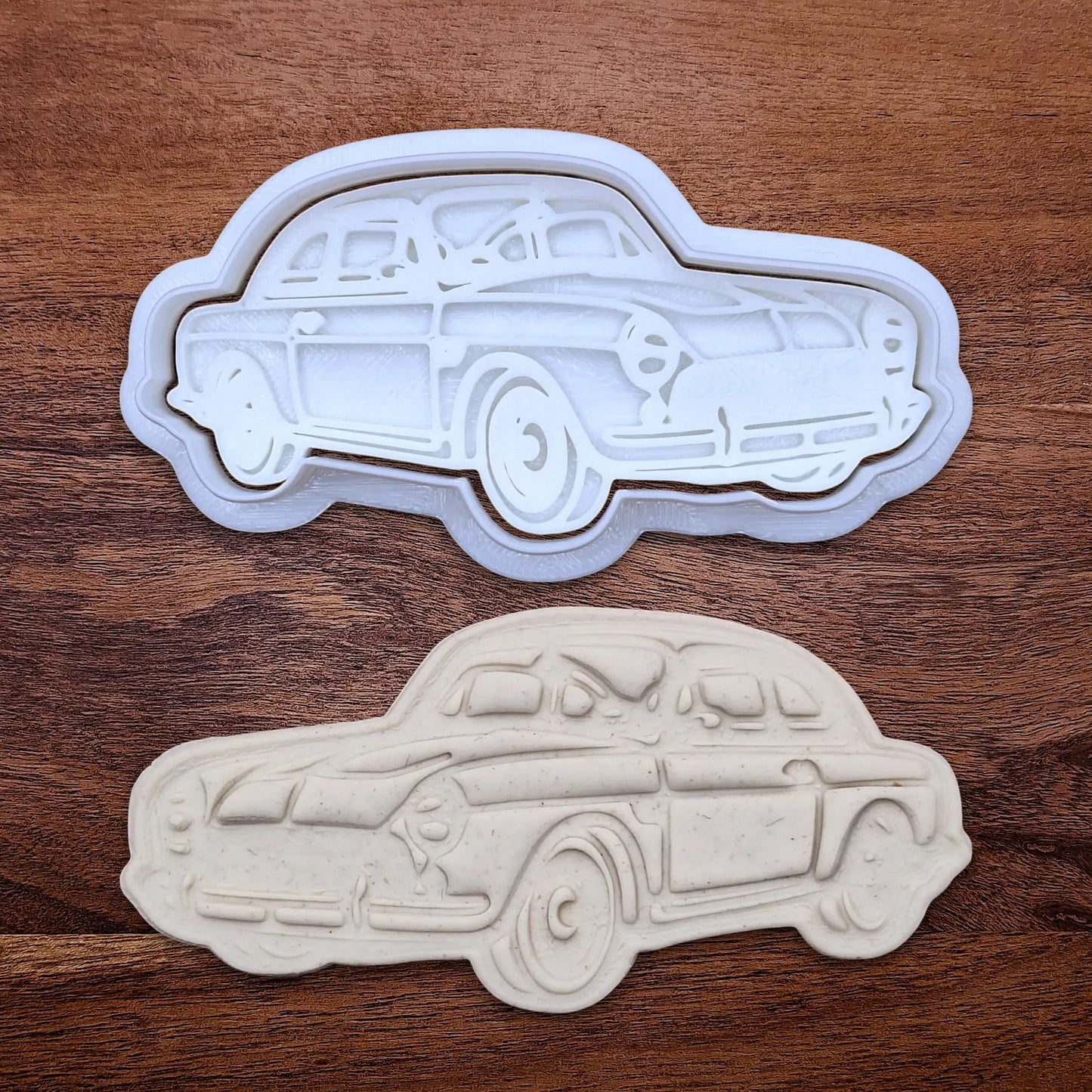 Handmade and customizable antique roadster car cookie cutter and stamp alongside a dough cutout and imprint, perfect for vintage car themed cookies, birthdays and gifting.