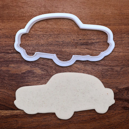 Handmade and customizable antique roadster car cookie cutter alongside a dough cutout, perfect for vintage car themed cookies, birthdays and gifting.