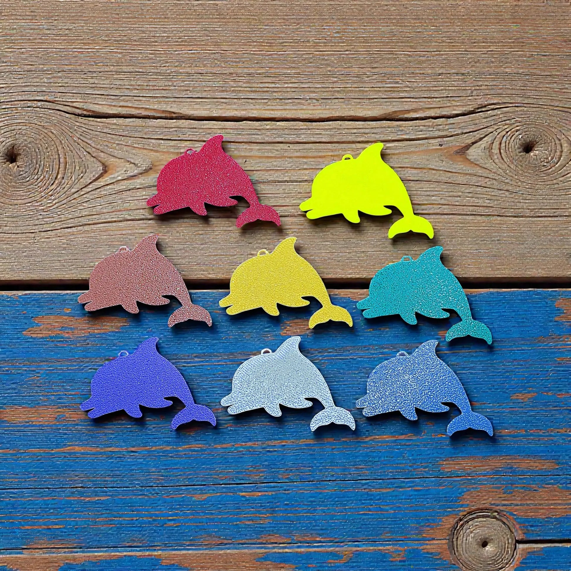 Reverse of handmade and customizable dolphin keychains in assorted colors, perfect for classroom prizes, party favors for kids birthdays, and unique bag charms.