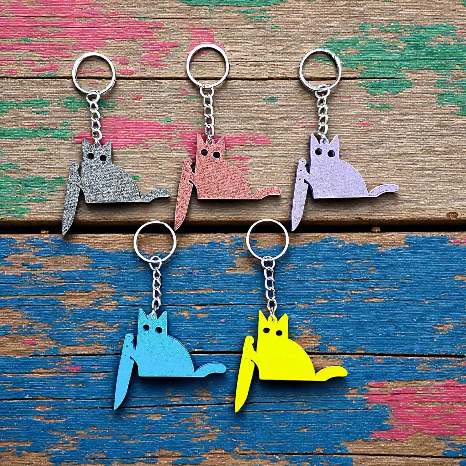 Five handmade and customizable black cat keychains in assorted colors, great for creepy cute key rings, trick or treat gifts, and Halloween parties.