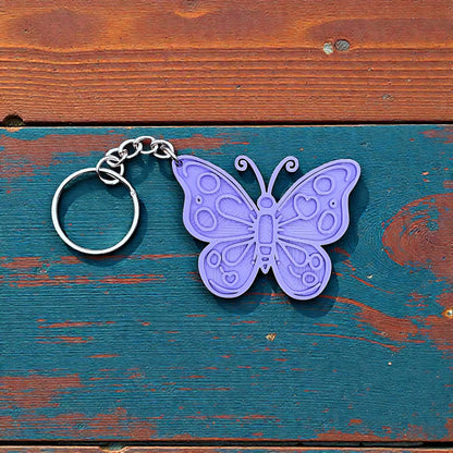 Handmade and customizable butterfly keychain in purple, perfect for gifts, party favors, or nature-themed accessories.