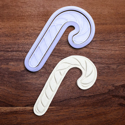 Handmade and customizable Christmas holiday Candy Cane Cookie Cutter and stamp alongside a dough cutout and imprint - stamp adds stripe details for Christmas cookies, festive gifts, and fun seasonal family baking activities.