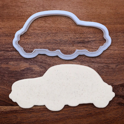 Handmade and customizable punch buggy car cookie cutter alongside a dough cutout, perfect for vintage car themed cookies, birthdays and gifting.