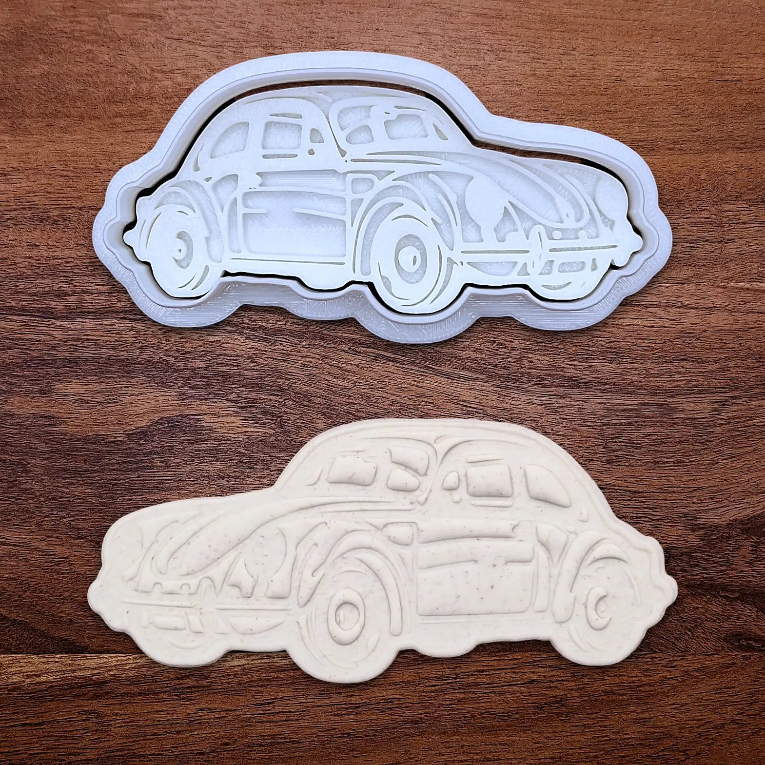 Handmade and customizable punch buggy car cookie cutter and stamp alongside a dough cutout and imprint, perfect for vintage car themed cookies, birthdays and gifting.
