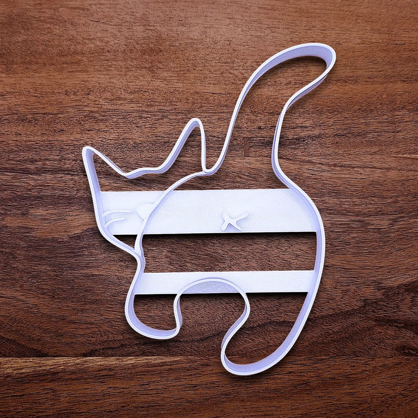 Front of handmade and customizable cat butt cookie cutter baking mold, perfect for gifting, gag gifts, white elephant gifting, and cat themed parties and treats.