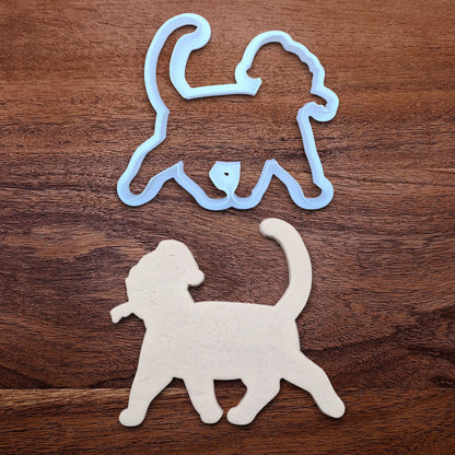 Funny Santa Hat Cat Butt Cookie Cutter alongside a cat butt dough cutout, available in a 3-piece set or individual sizes, perfect for baking, fondant, crafts, gag gifts and white elephant parties.