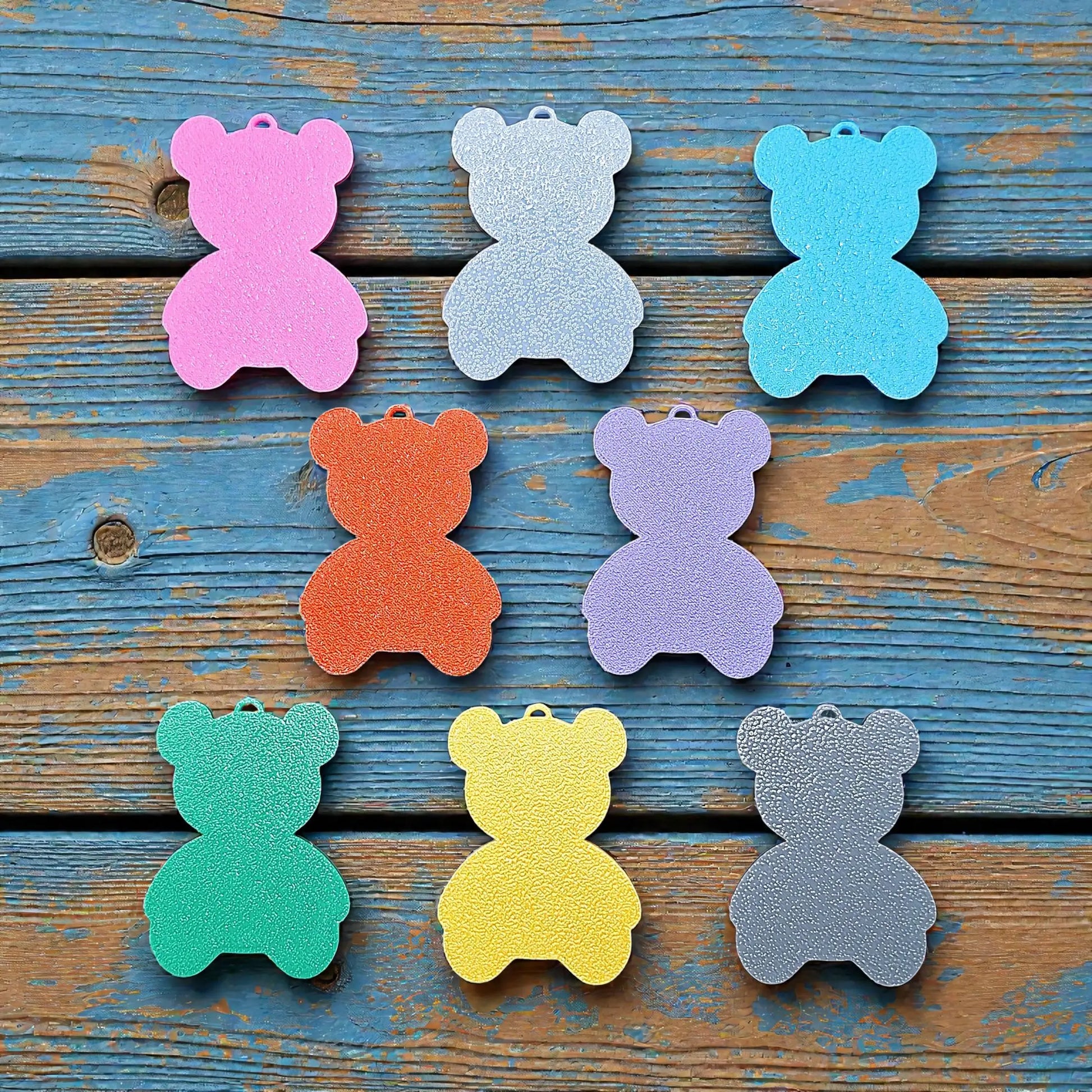 Reverse view of colorful teddy bear keychains in various colors - handmade eco-friendly charms perfect for kids, baby showers, party favors, or animal-themed gifts.