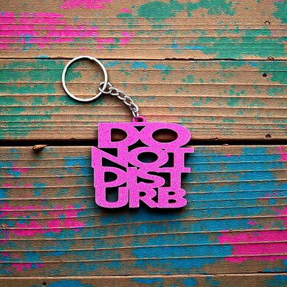 Handmade and customizable Do Not Disturb keychain in magenta, perfect gift for introverts or gamers.