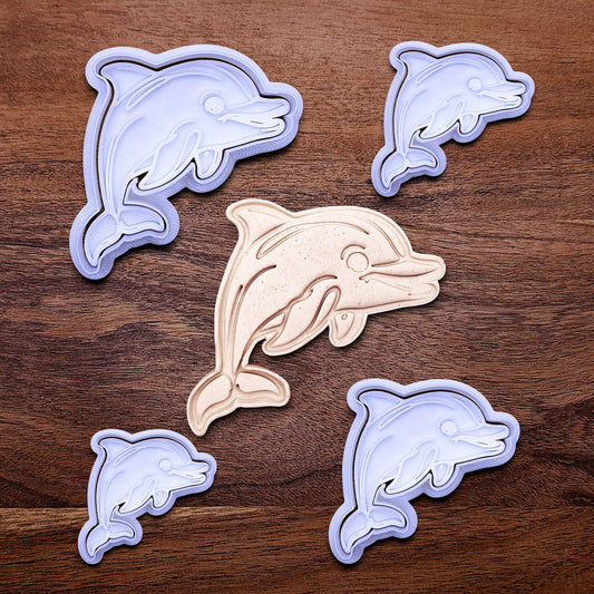 Handmade and customizable dolphin cookie cutter stamp set in multiple sizes alongside a dough imprint, perfect for ocean-themed cookies, birthdays, aquatic fondant toppers, and sea animal baking projects.