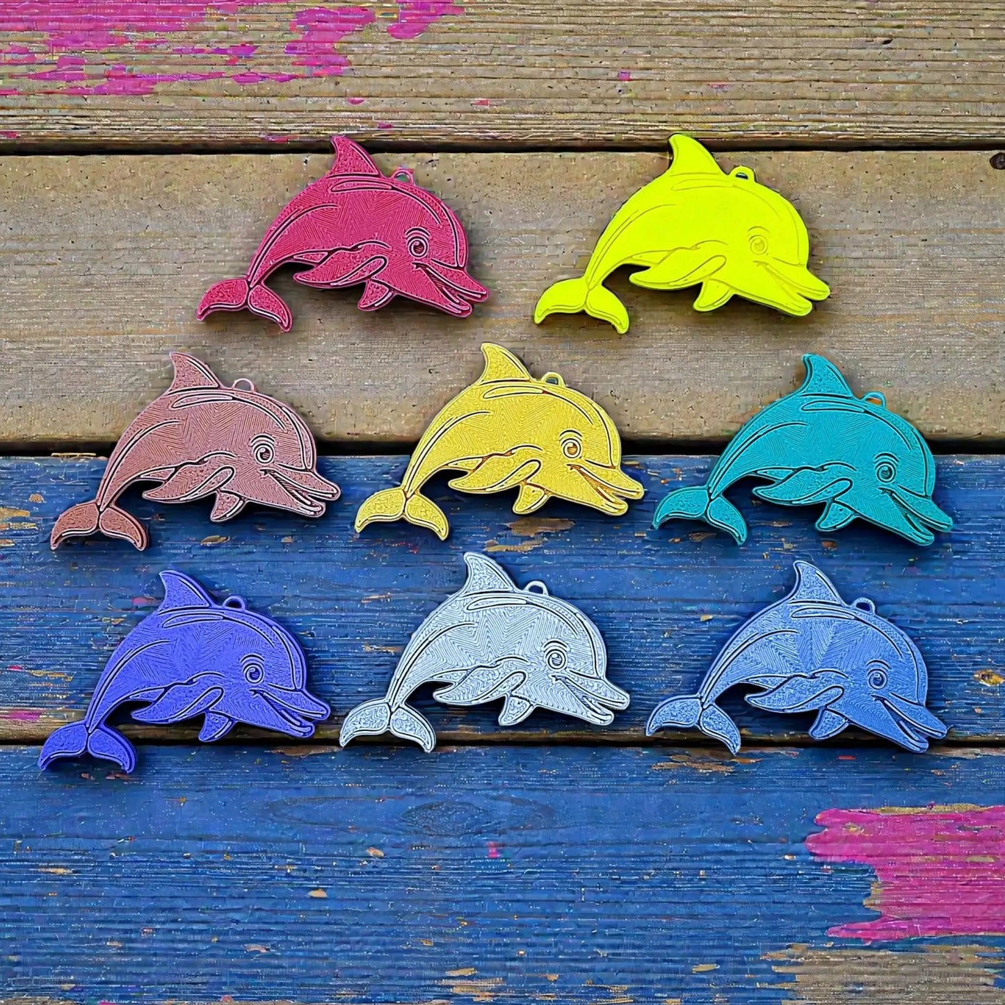 Handmade and customizable dolphin keychains in various colors featuring a friendly aquatic design, perfect for classroom prizes, party favors for kids birthdays, and unique bag charms.