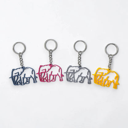Four elephant-shaped keychains in different colors on a white background