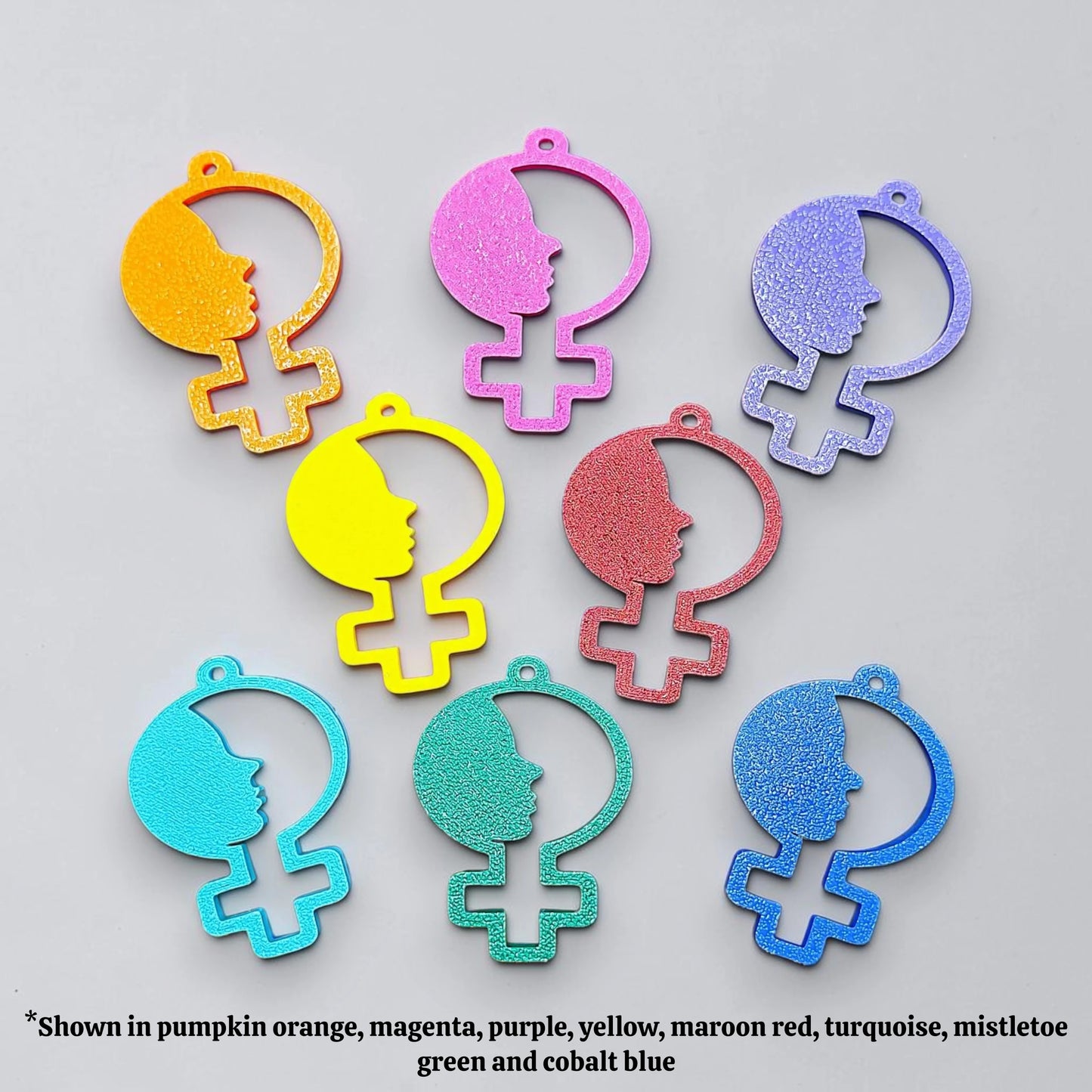 Handmade and customizable women empowerment keychains in various colors, perfect for event giveaways and gifts for feminists.