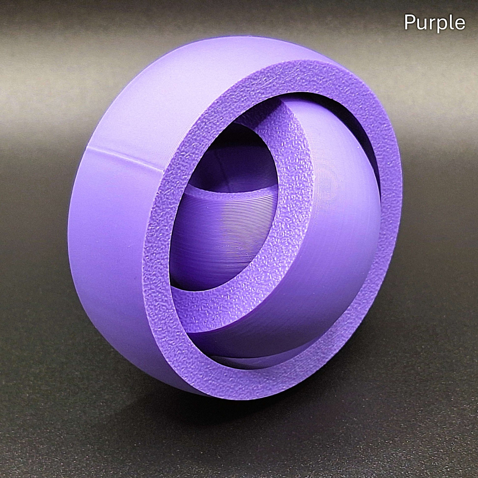 Purple smooth gyro spinner with a sleek, seamless exterior, made from biodegradable PLA for anxiety relief and quiet sensory play.