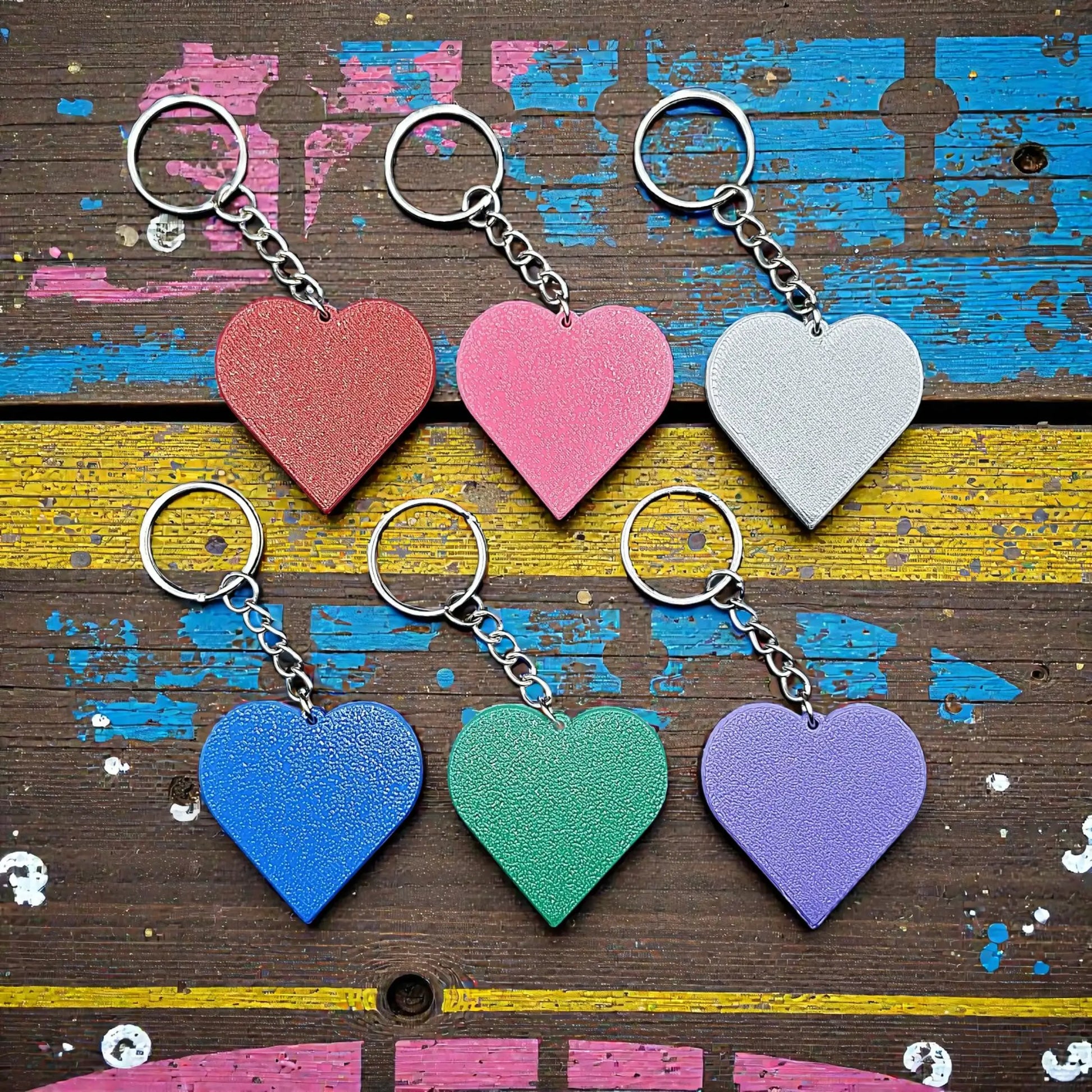 Handmade and customizable heart keychains in assorted colors, perfect for classroom prizes, Valentine's Day gifts, party favors for kids birthdays, baby showers and unique backpack charms.
