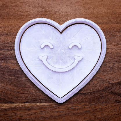 Handmade and customizable heart cookie cutter with cute face stamp, perfect for Valentine's Day baking, sweet treats and party favor creations.