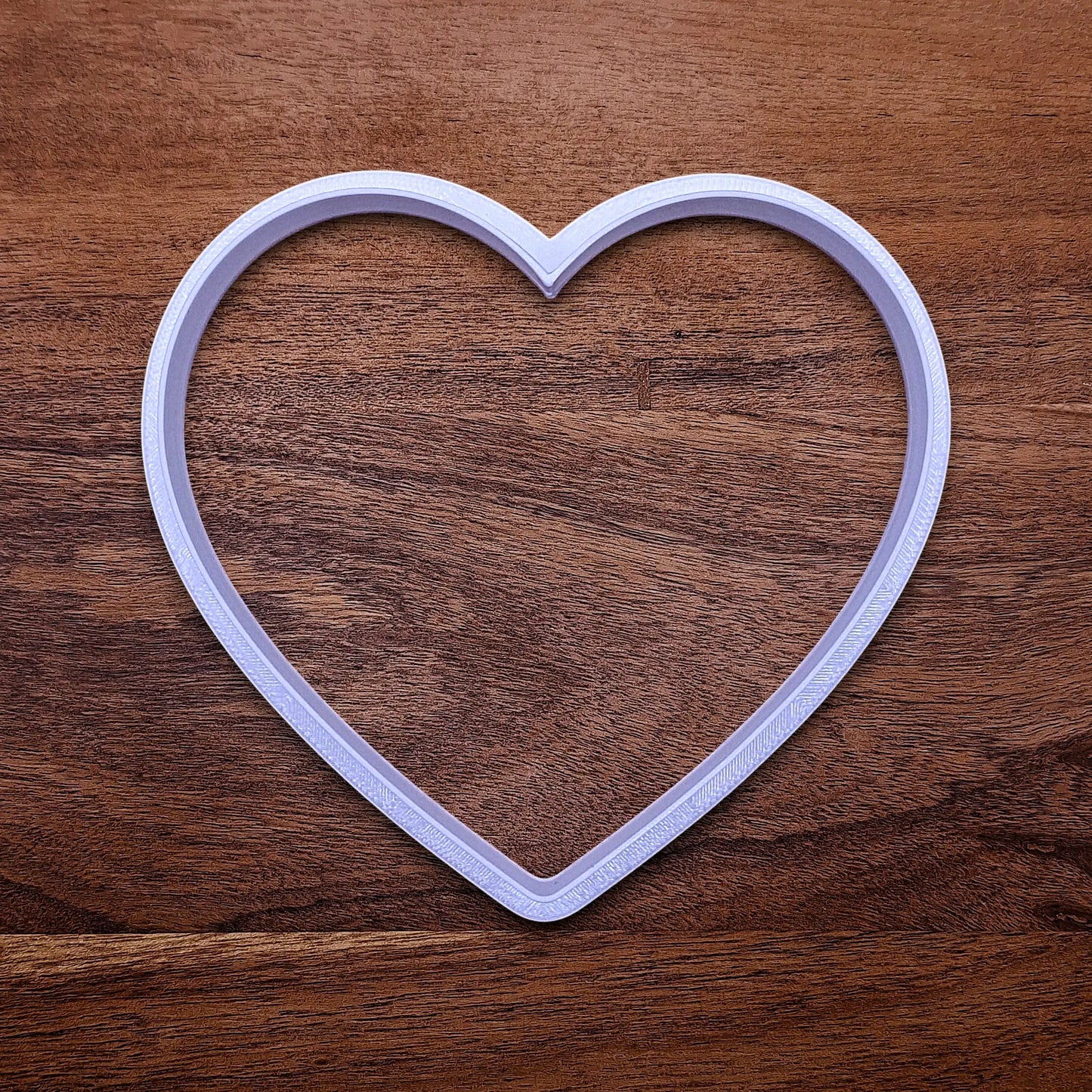 Handmade and customizable heart cookie cutter, perfect for Valentine's Day baking, sweet treats and party favor creations.