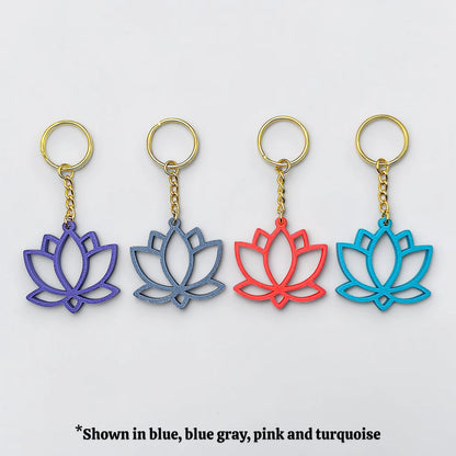 Four lotus flower keychains in blue, blue gray, pink, and turquoise on a white background.