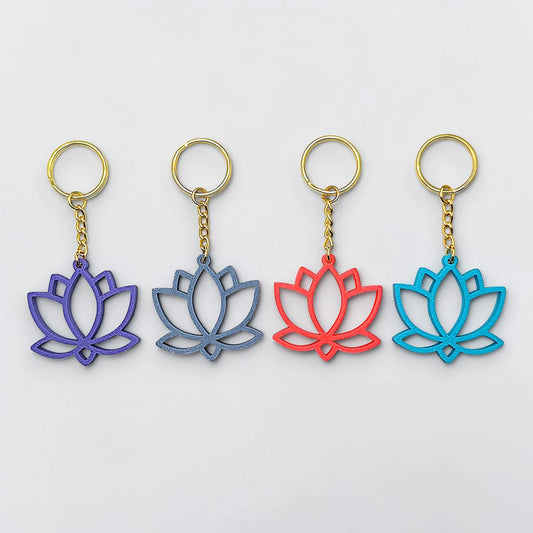 Four lotus flower keychains in purple, blue, red, and blue on a white background
