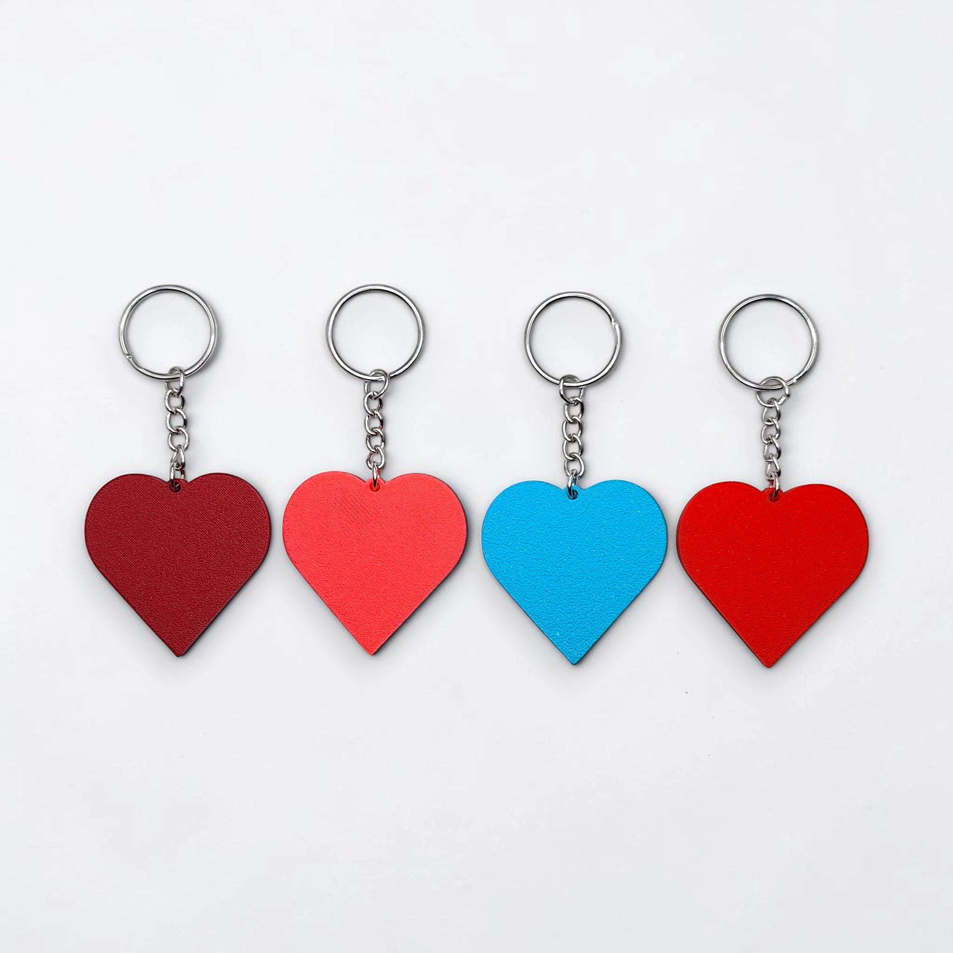 Handmade and customizable heart keychains in assorted colors, perfect for classroom prizes, Valentine's Day gifts, party favors for kids birthdays, baby showers and unique backpack charms.