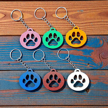 Handmade and customizable paw print keychains in assorted colors, perfect for pet lovers, events and animal themed gifts.
