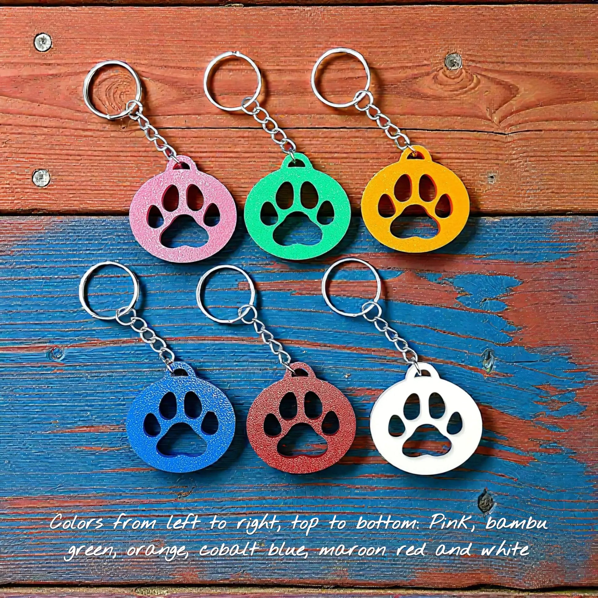 Handmade and customizable paw print keychains in six colors, perfect for pet lovers, events and animal themed gifts.